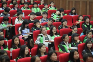 Bright faces of the young volunteers gathered for a youth forum.