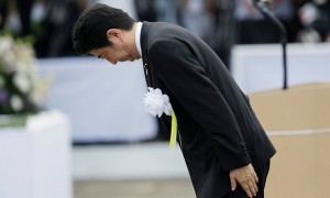 Shinzo Abe bows in front of the Peace Prayer statue in Nagasaki. It is expected he will include the word ‘apology’ in an anniversary statement later this week. Photograph: Kimimasa Mayama/EPA
