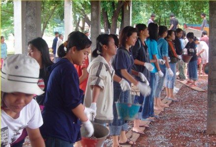 Local and international volunteers come out to rebuild a village after a tsunami in Thailand.