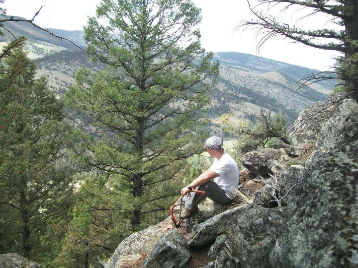 A member of GPYC-USA looks over the cliff he scaled during a mountain challenge program in Montana lead by True North Adventures Outdoor Education.