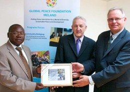 Arnold Kashembe, Country Director for Global Peace Foundation, receiving a presentation from Martin Quinn, Hon. Secretary of Tipperary Peace Convention, with Global Peace Foundation Vice President Dr. Tony Devine. PHOTO: COURTESY OF CAITRIONA KENNY PHOTOGRAPHY / THE NATIONALIST (TIPPERARY) 