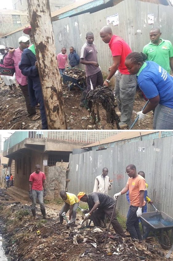 Daniel Juma, Executive Director of GPF-Kenya with youth from Kariobangi shovel garbage out of ditches during the city-wide Clean-up Day.