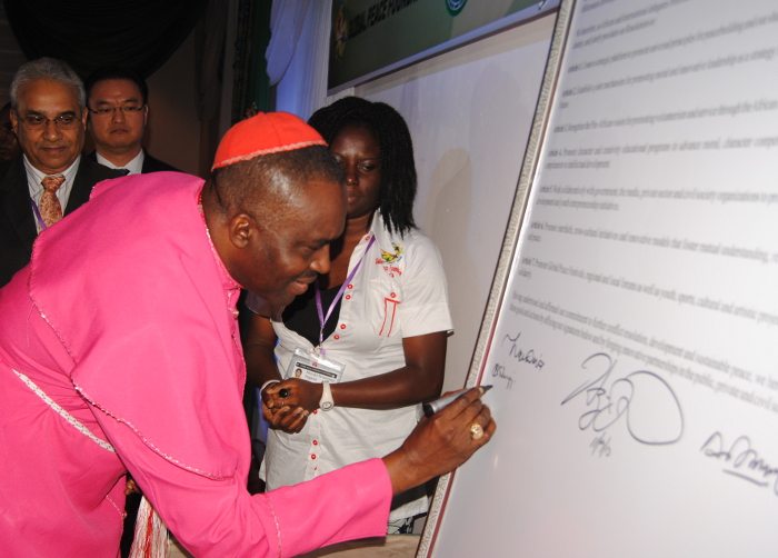 Bishop Sunday Onuoha adding his signature to the Abuja Declaration