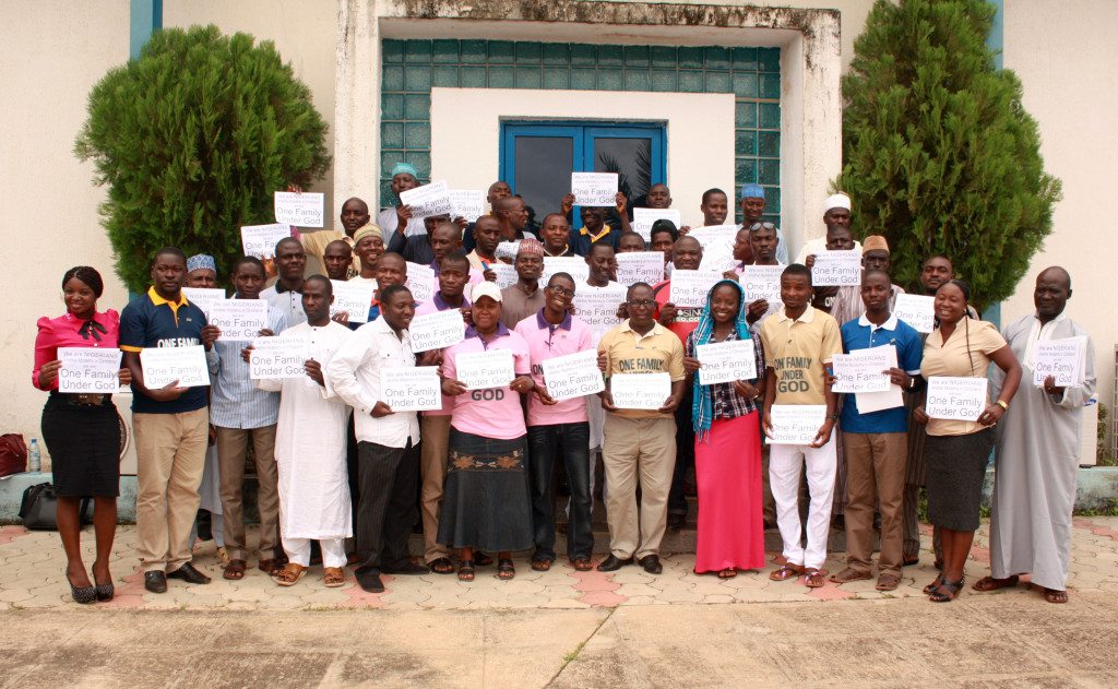 Leaders holding One Family Under God group picture