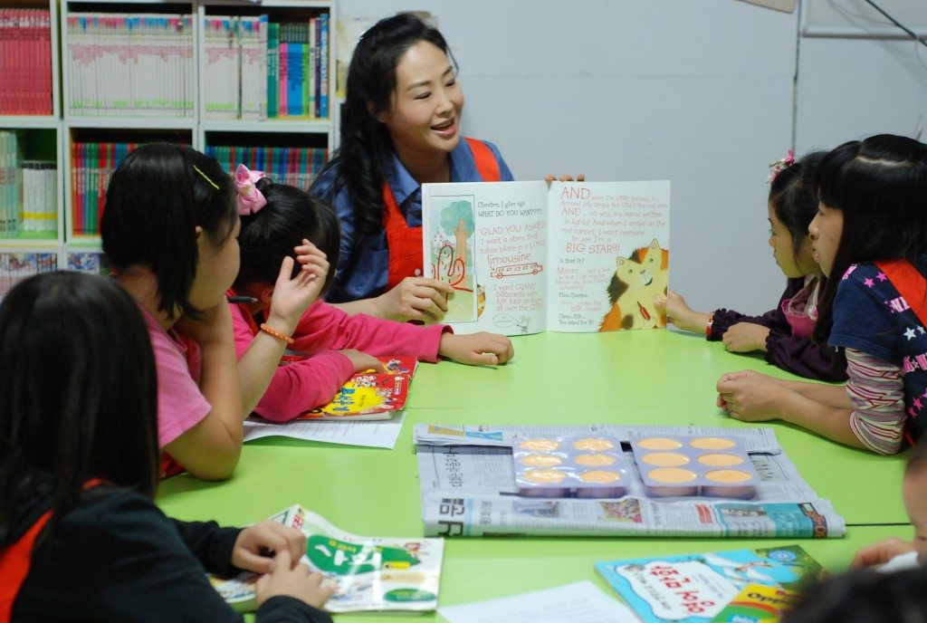 Jun Sook Moon reading to children at at family shelter in Korea.