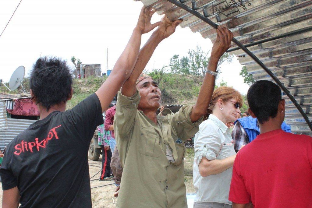 RiseNepal Volunteers, supported by the Global Peace Foundation, members of the Asia Pacific Peace and Development Service Alliance and and United Kingdom NGO Byond, raise a transitional shelter in (village name) for victims of the April 25 earthquake that hit central Nepal.