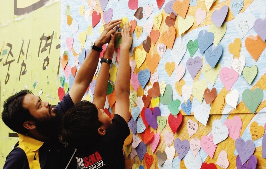 Foreigners putting leaf on Unification Tree