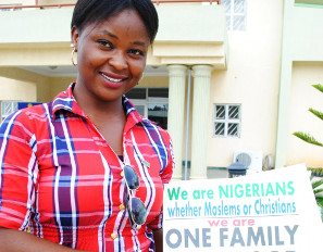 Participant holding a One Family under God sign