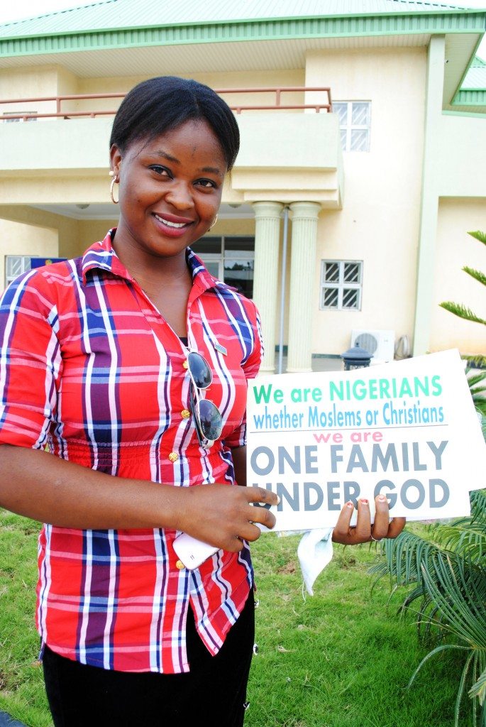 Participant holding a One Family under God sign 