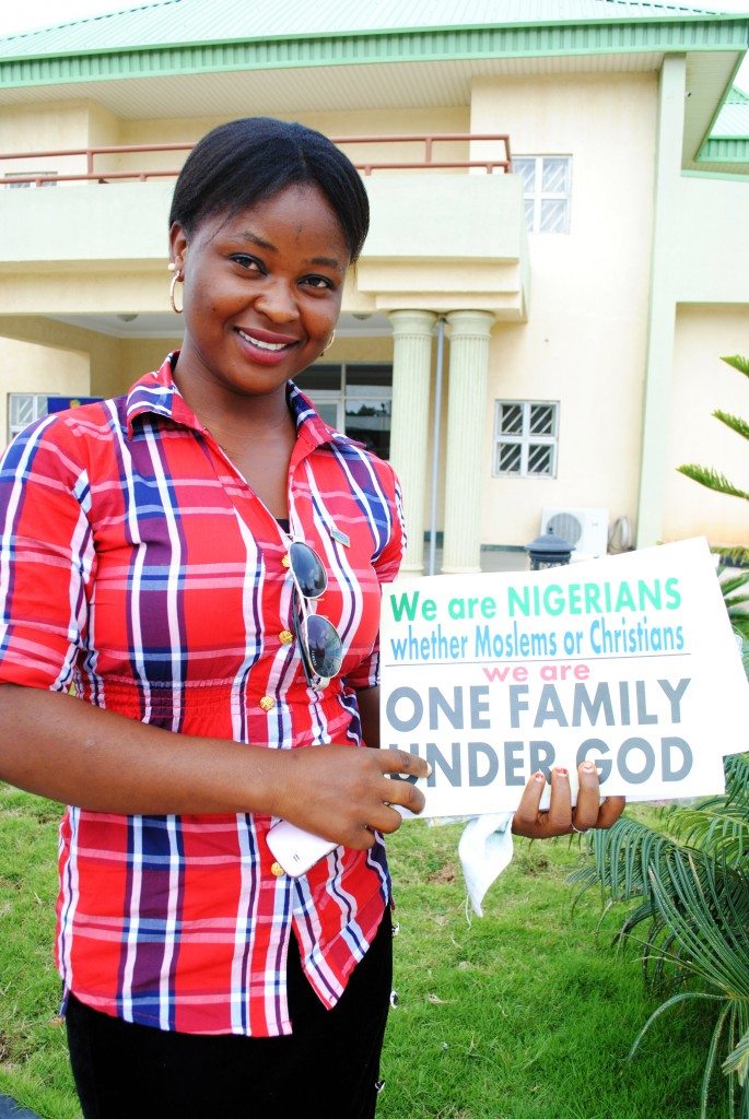 Participant holding a One Family under God sign