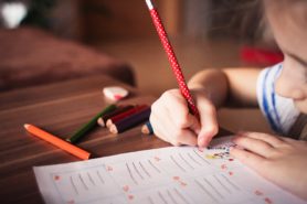 small girl writing 