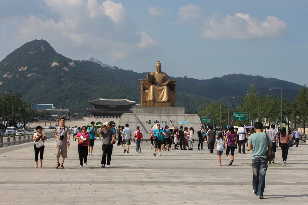 Tourists and locals in the Square of Gyeongbokgung Palace in Seoul, South Korea