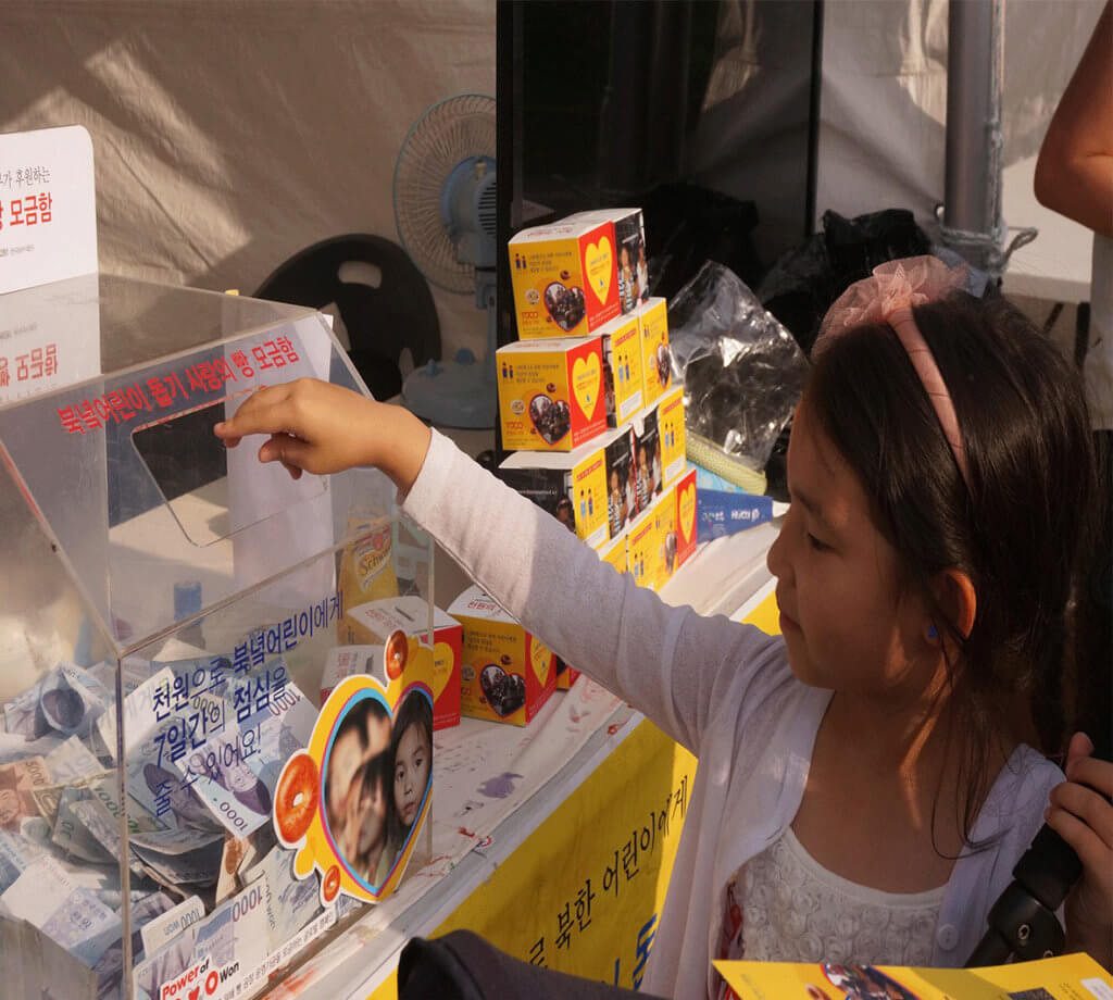 Providing humanitarian aid through projects like 1000 Won, giving bread to children in North Korea.