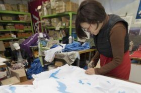 A worker in Seoul, South Korea, makes Korean unification flags, which depict a blue silhouette of the Korean Peninsula on a white background, at a sponsoring company of next month's Pyeongchang Winter Olympics. Photo by Yonhap