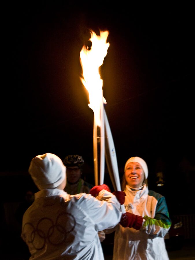The 2010 flame passes from one torch to another